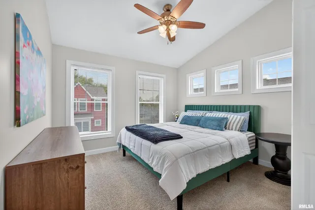 a bedroom with a bed dresser and a window