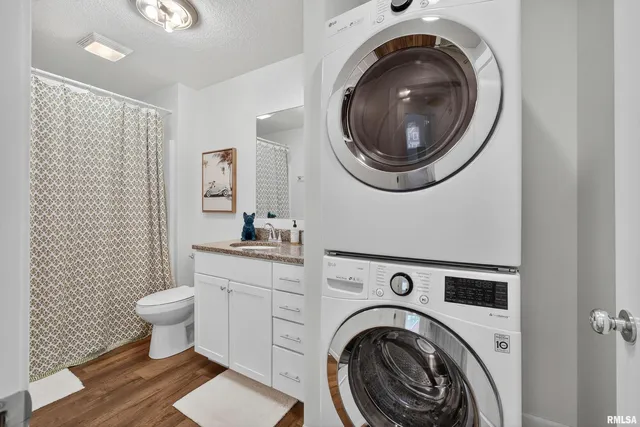 a view of a bathroom with washing machine and toilet