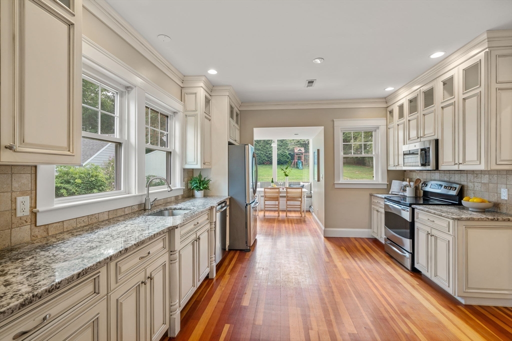 44 Norfolk Street Needham, MA 02492 - Photo 13 of 28 a kitchen with stainless steel appliances granite countertop sink stove top oven and cabinets