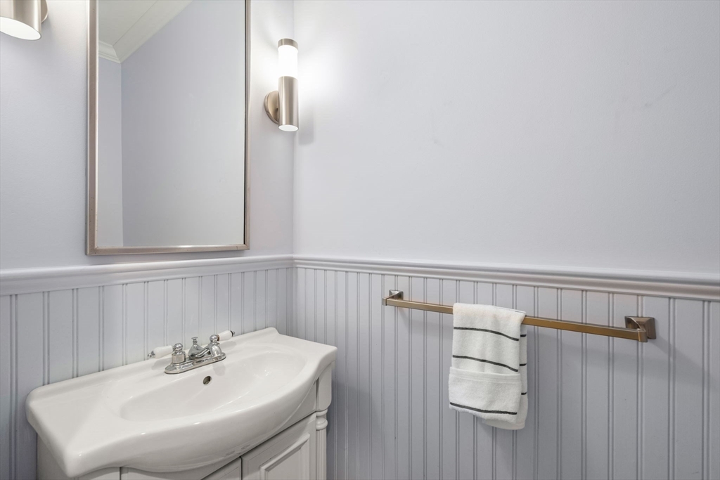 44 Norfolk Street Needham, MA 02492 - Photo 17 of 28 a bathroom with a sink and mirror