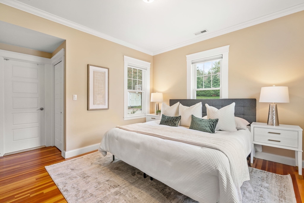 44 Norfolk Street Needham, MA 02492 - Photo 18 of 28 a bedroom with a bed and wooden floor