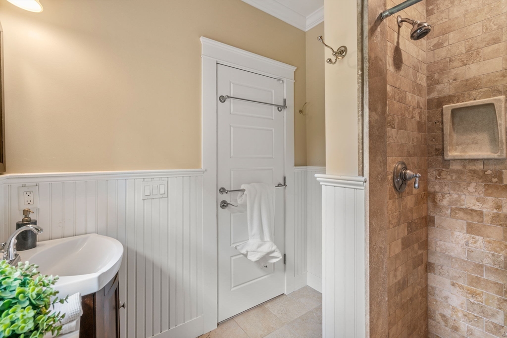 44 Norfolk Street Needham, MA 02492 - Photo 20 of 28 a bathroom with a tub a sink and a shower