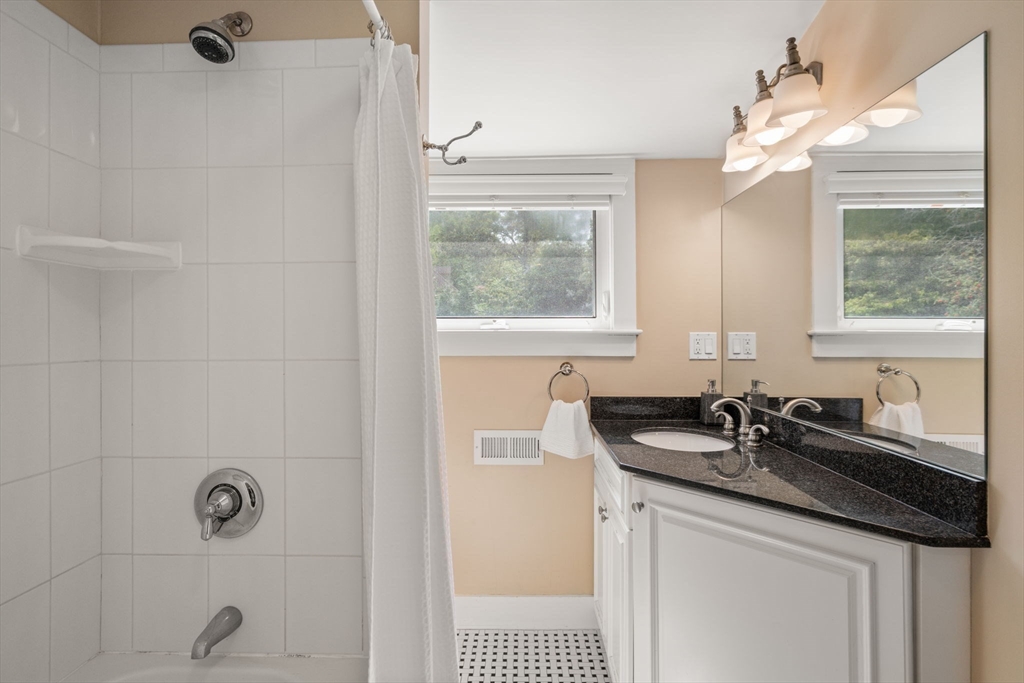 44 Norfolk Street Needham, MA 02492 - Photo 25 of 28 a bathroom with a granite countertop sink a window and a mirror