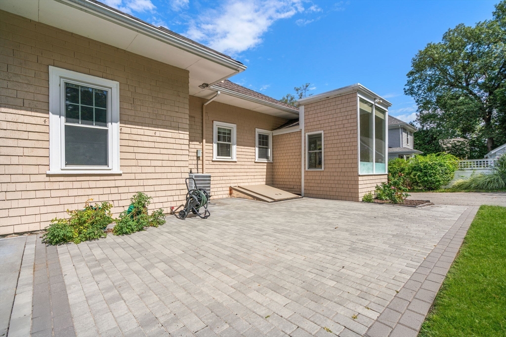 44 Norfolk Street Needham, MA 02492 - Photo 26 of 28 a front view of a house with a yard and garage
