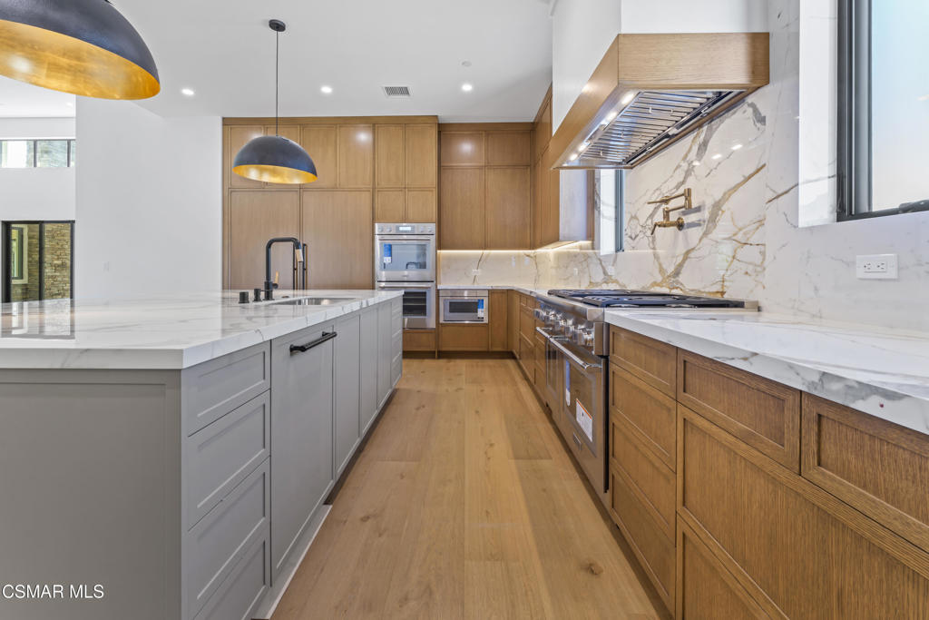 532 Corte Corrida Camarillo, CA 93010 - Photo 15 of 76 a large kitchen with stainless steel appliances granite countertop a sink and cabinets
