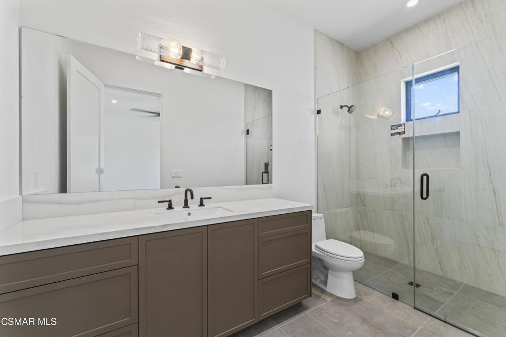 532 Corte Corrida Camarillo, CA 93010 - Photo 30 of 76 a bathroom with a double vanity sink toilet and shower