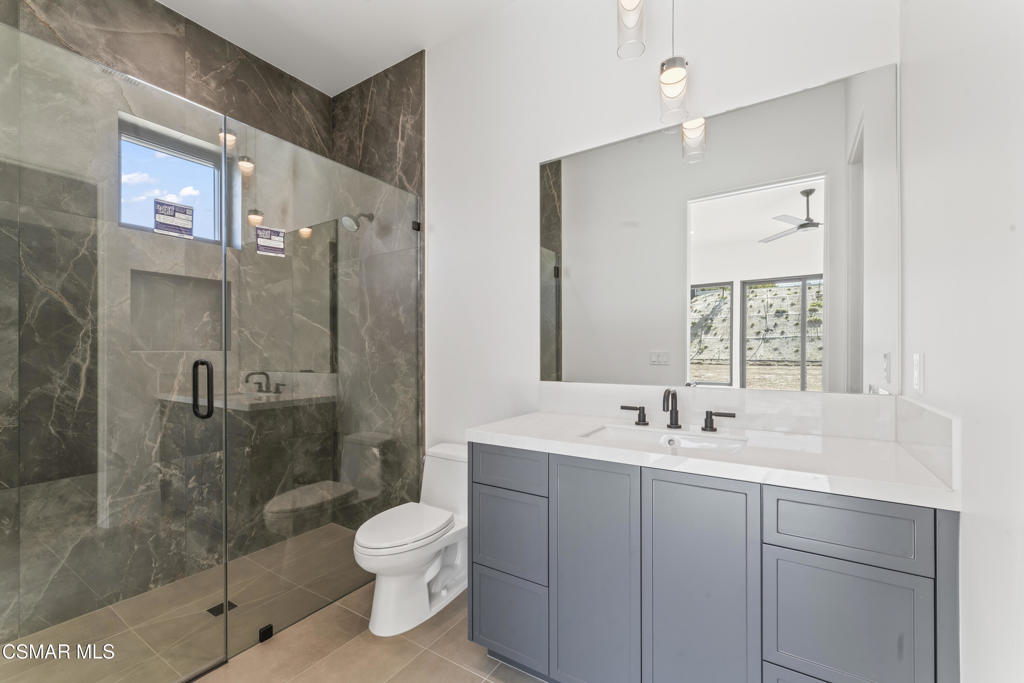 532 Corte Corrida Camarillo, CA 93010 - Photo 33 of 76 a bathroom with a double vanity sink toilet mirror and shower