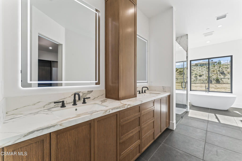 532 Corte Corrida Camarillo, CA 93010 - Photo 37 of 76 a bathroom with a sink double vanity and a mirror