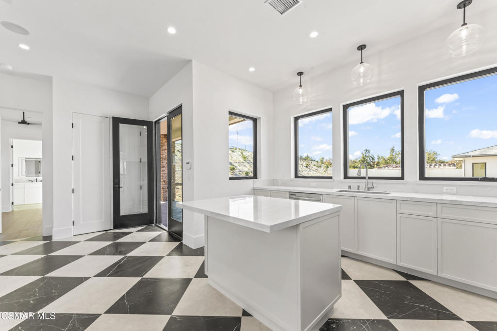 532 Corte Corrida Camarillo, CA 93010 - Photo 45 of 76 a large white kitchen with a sink and large window