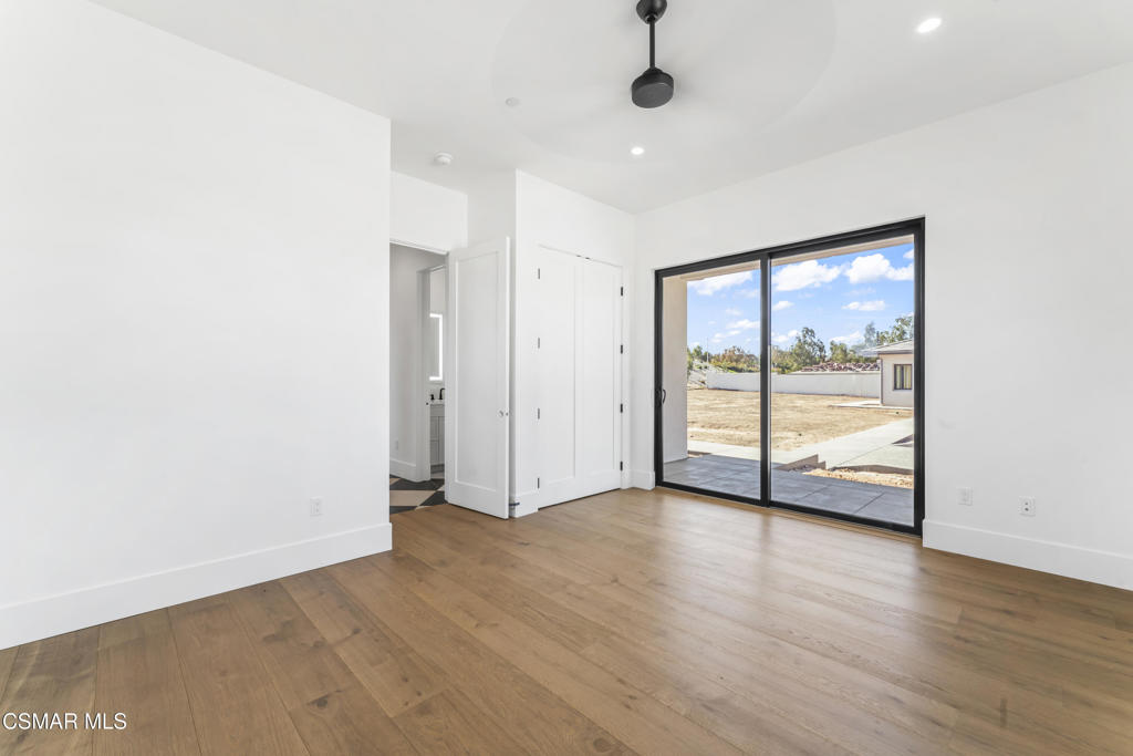 532 Corte Corrida Camarillo, CA 93010 - Photo 53 of 76 an empty room with wooden floor and windows with curtains