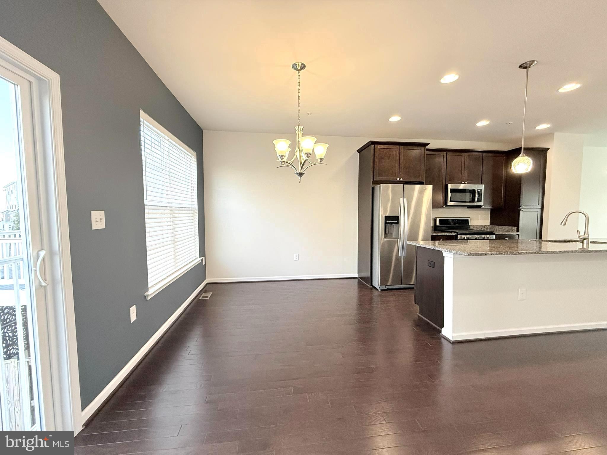 6082 Forum Square Frederick, MD 21703 - Photo 16 of 63 a view of a kitchen with refrigerator and wooden floor