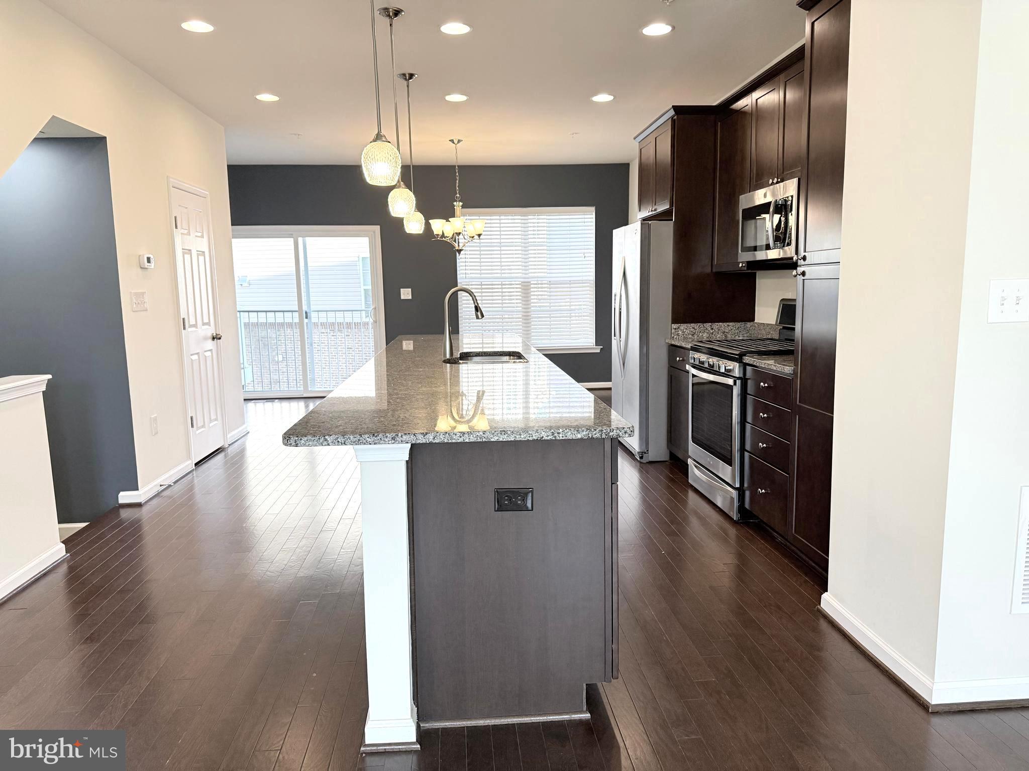 6082 Forum Square Frederick, MD 21703 - Photo 26 of 63 a kitchen with stainless steel appliances granite countertop a refrigerator a stove and a wooden floors