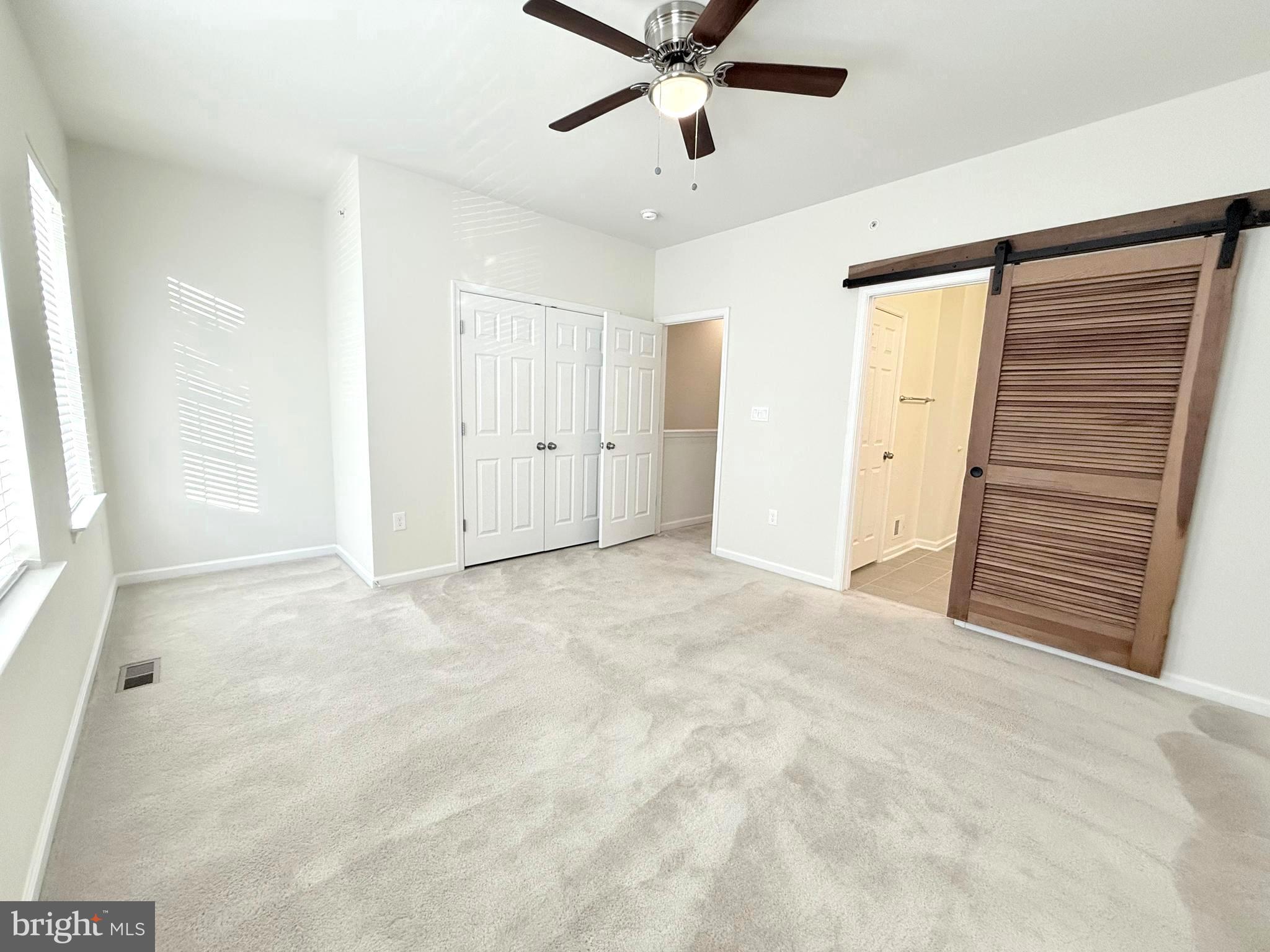 6082 Forum Square Frederick, MD 21703 - Photo 44 of 63 a view of a livingroom with a ceiling fan and window