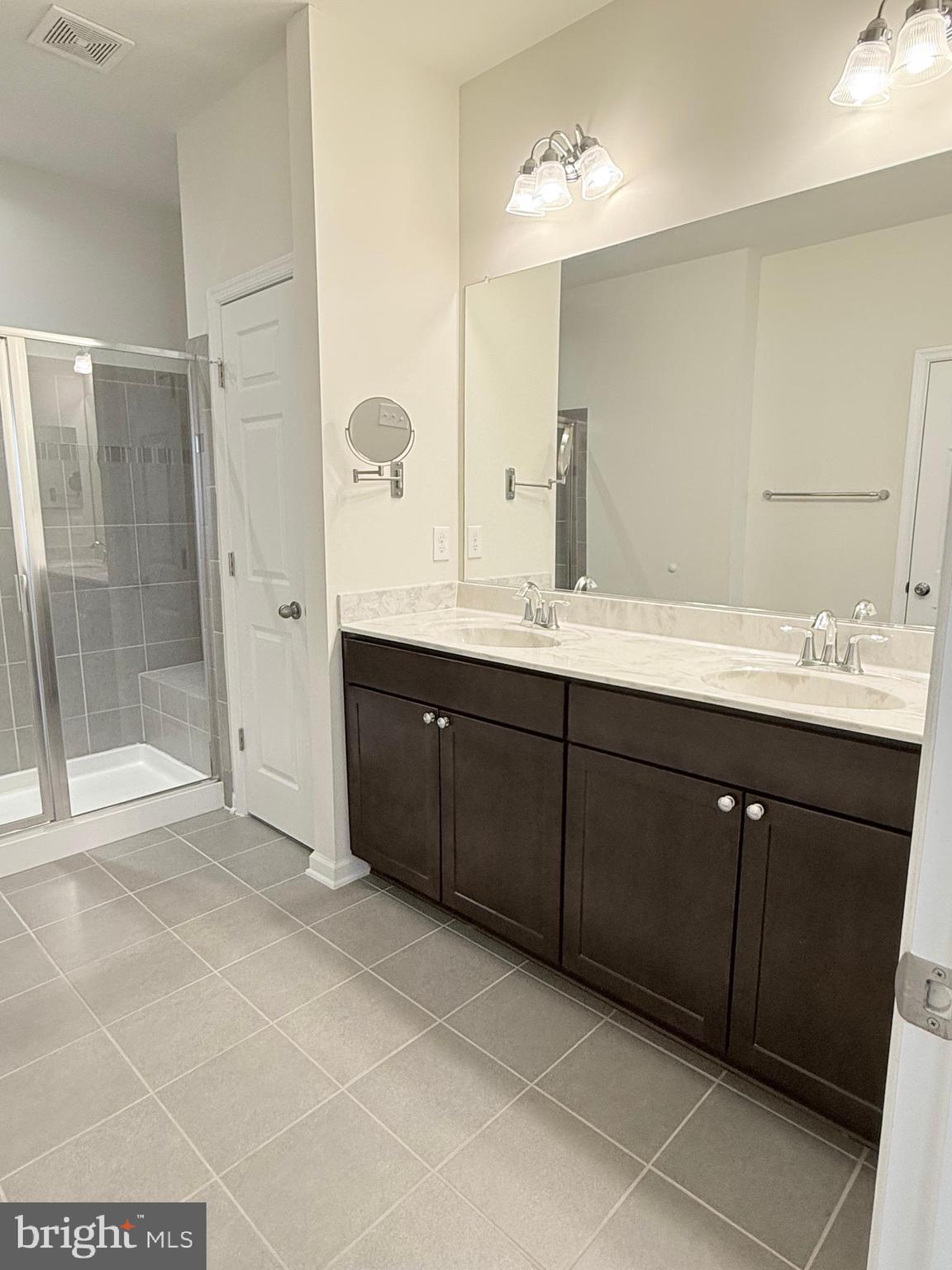 6082 Forum Square Frederick, MD 21703 - Photo 46 of 63 a spacious bathroom with a mirror sink and shower