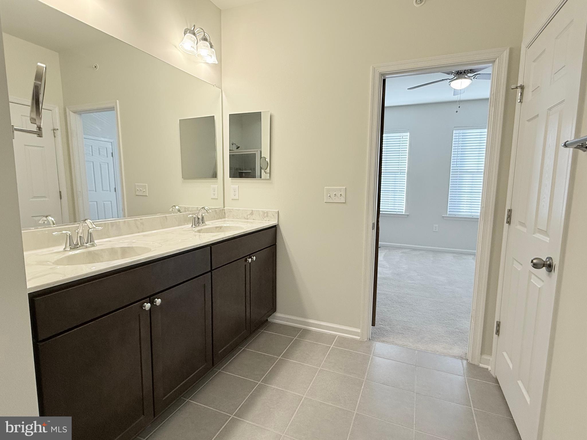 6082 Forum Square Frederick, MD 21703 - Photo 50 of 63 a bathroom with a double vanity sink and mirror