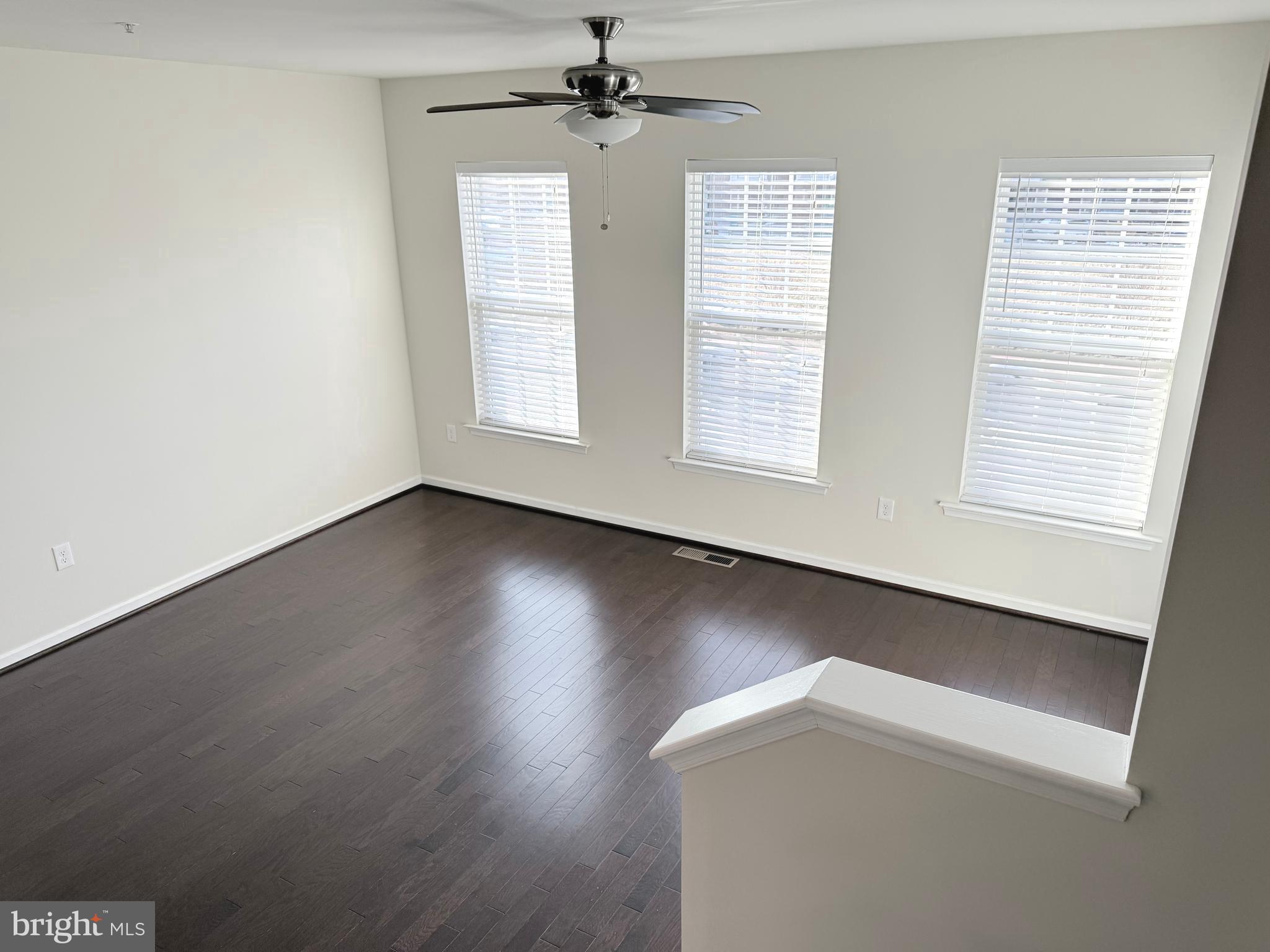 6082 Forum Square Frederick, MD 21703 - Photo 55 of 63 a view of an empty room with wooden floor and a window