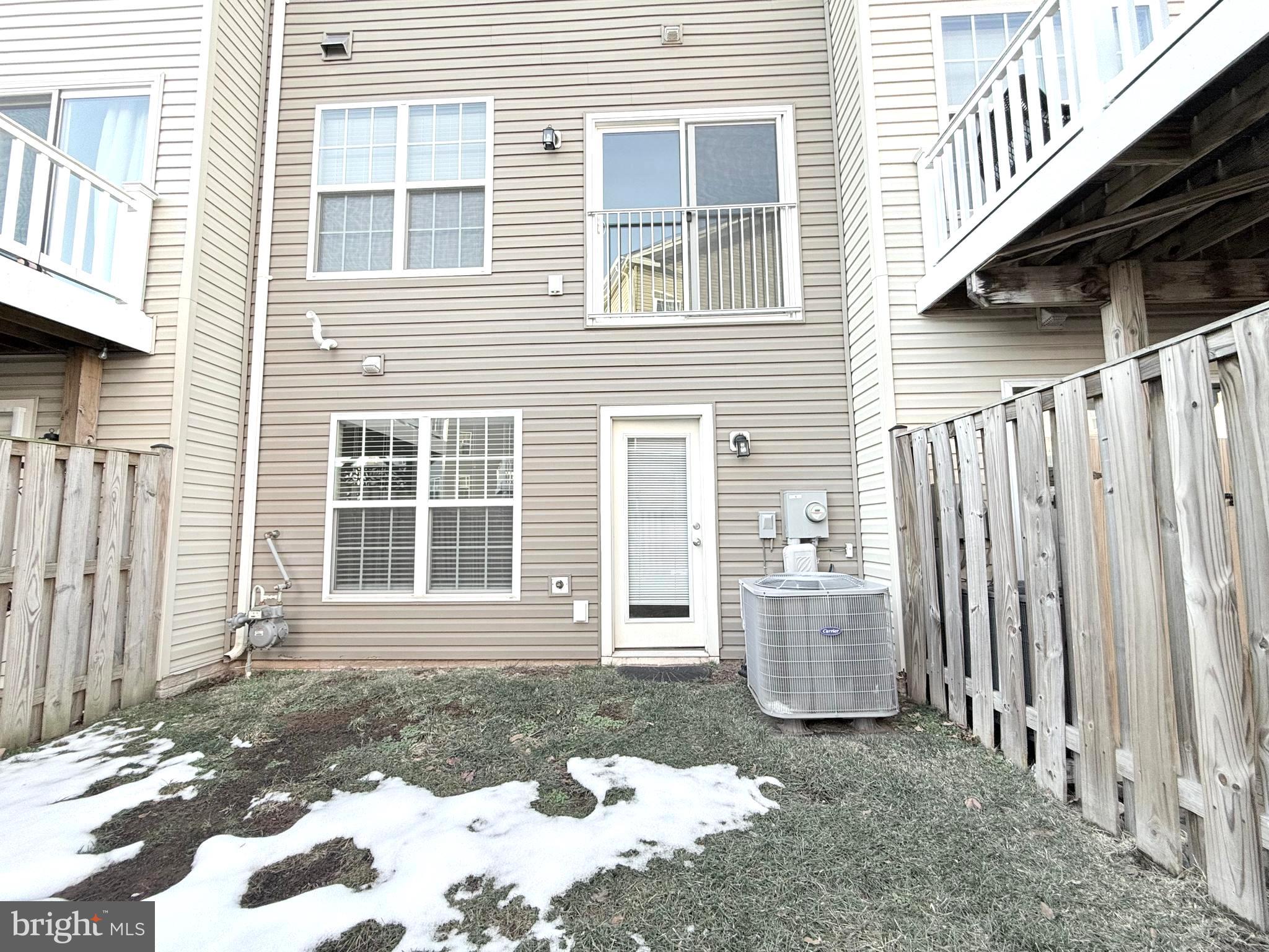 6082 Forum Square Frederick, MD 21703 - Photo 58 of 63 a front view of a house with a yard