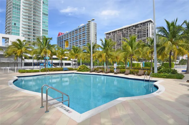 a view of swimming pool with outdoor seating and plants