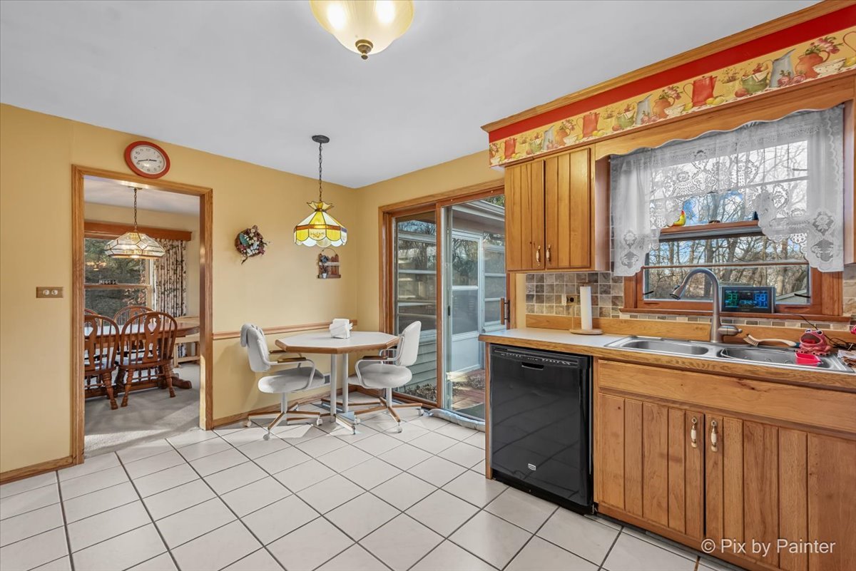 612-3 Three Oaks Road Cary, IL 60013 - Photo 13 of 48 a kitchen with a sink and chairs