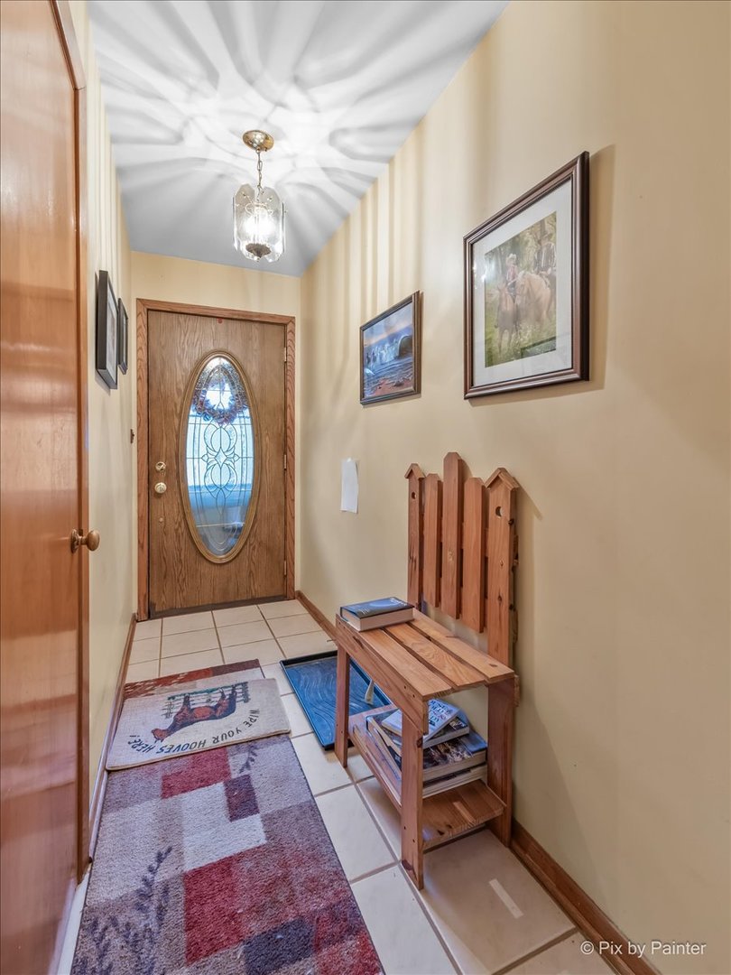 612-3 Three Oaks Road Cary, IL 60013 - Photo 7 of 48 a living room with furniture a chandelier and a rug