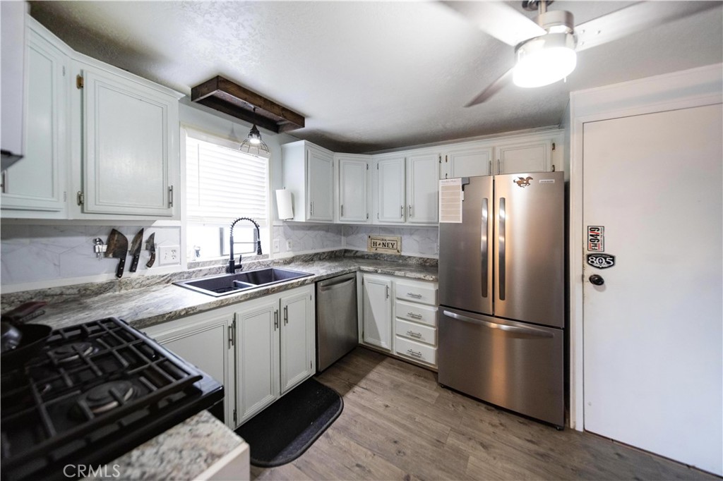 33671 The Farm Road Wildomar, CA 92595 - Photo 2 of 73 a kitchen with stainless steel appliances a refrigerator sink and white cabinets
