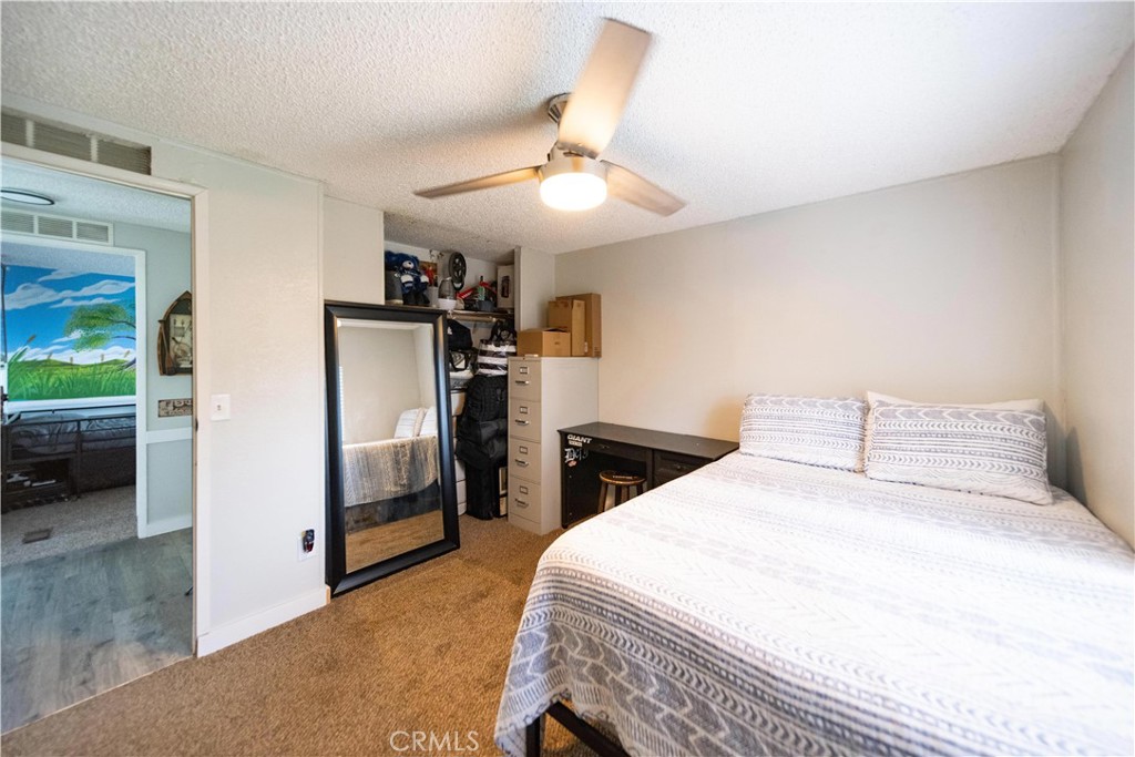 33671 The Farm Road Wildomar, CA 92595 - Photo 29 of 73 a bedroom with a bed and a refrigerator