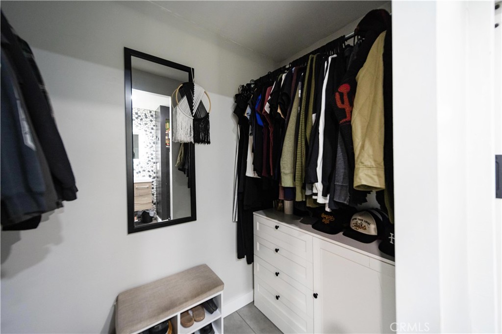33671 The Farm Road Wildomar, CA 92595 - Photo 38 of 73 a view of walk in closet with clothes and shoes