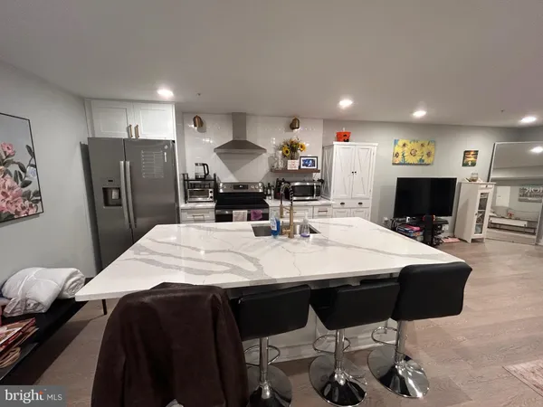 a large kitchen with a table and chairs