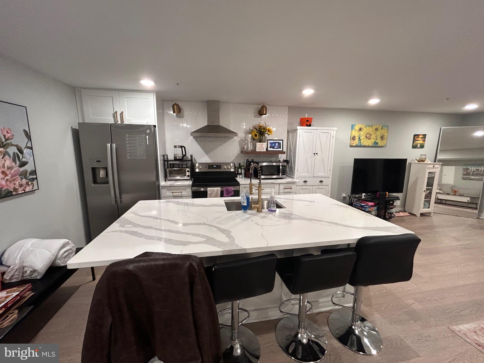 a large kitchen with a table and chairs