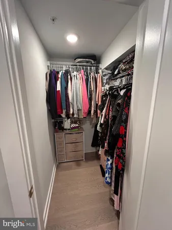 a view of walk in closet with clothes
