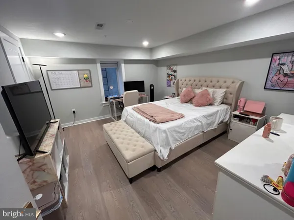 a bedroom with bed and a flat screen tv