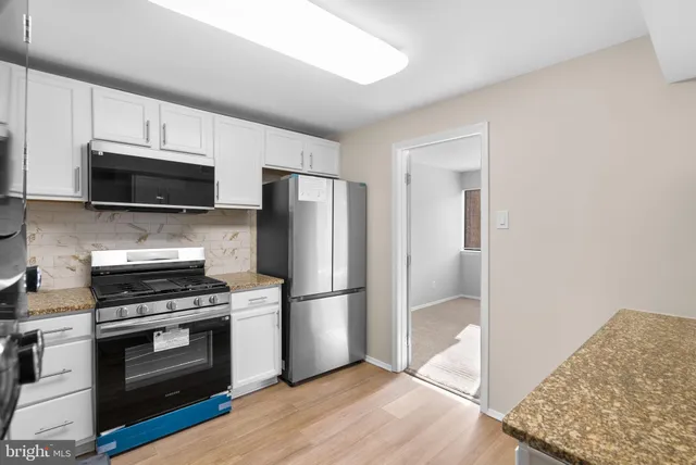 a kitchen with a refrigerator stove and microwave
