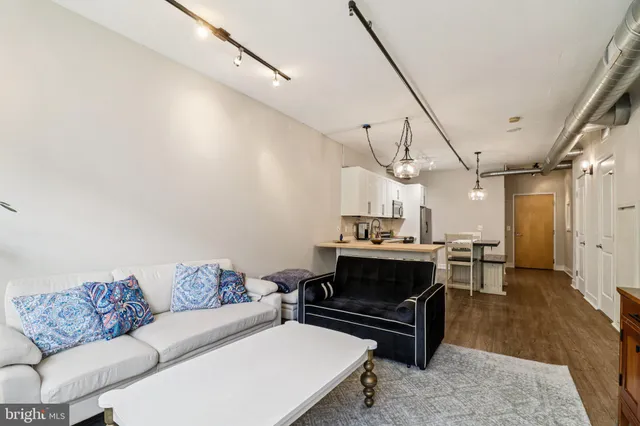a living room with lots of furniture and a chandelier
