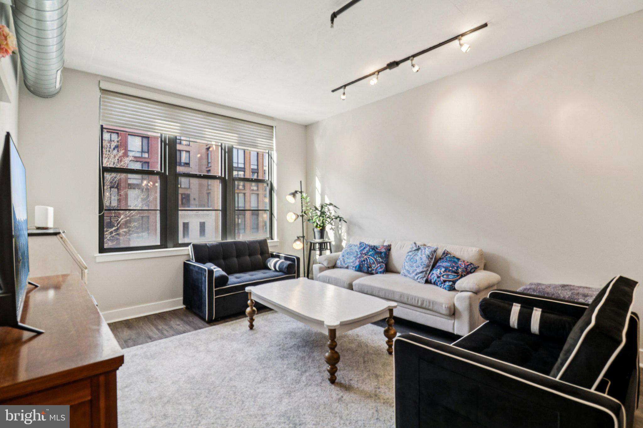 2125 14th Street Northwest, Unit 322 Washington, DC 20009 - Photo 14 of 37 a living room with furniture and a window