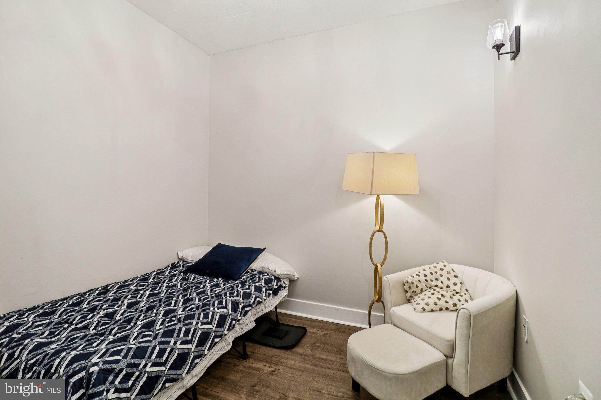 2125 14th Street Northwest, Unit 322 Washington, DC 20009 - Photo 20 of 37 a bedroom with a bed and a chair