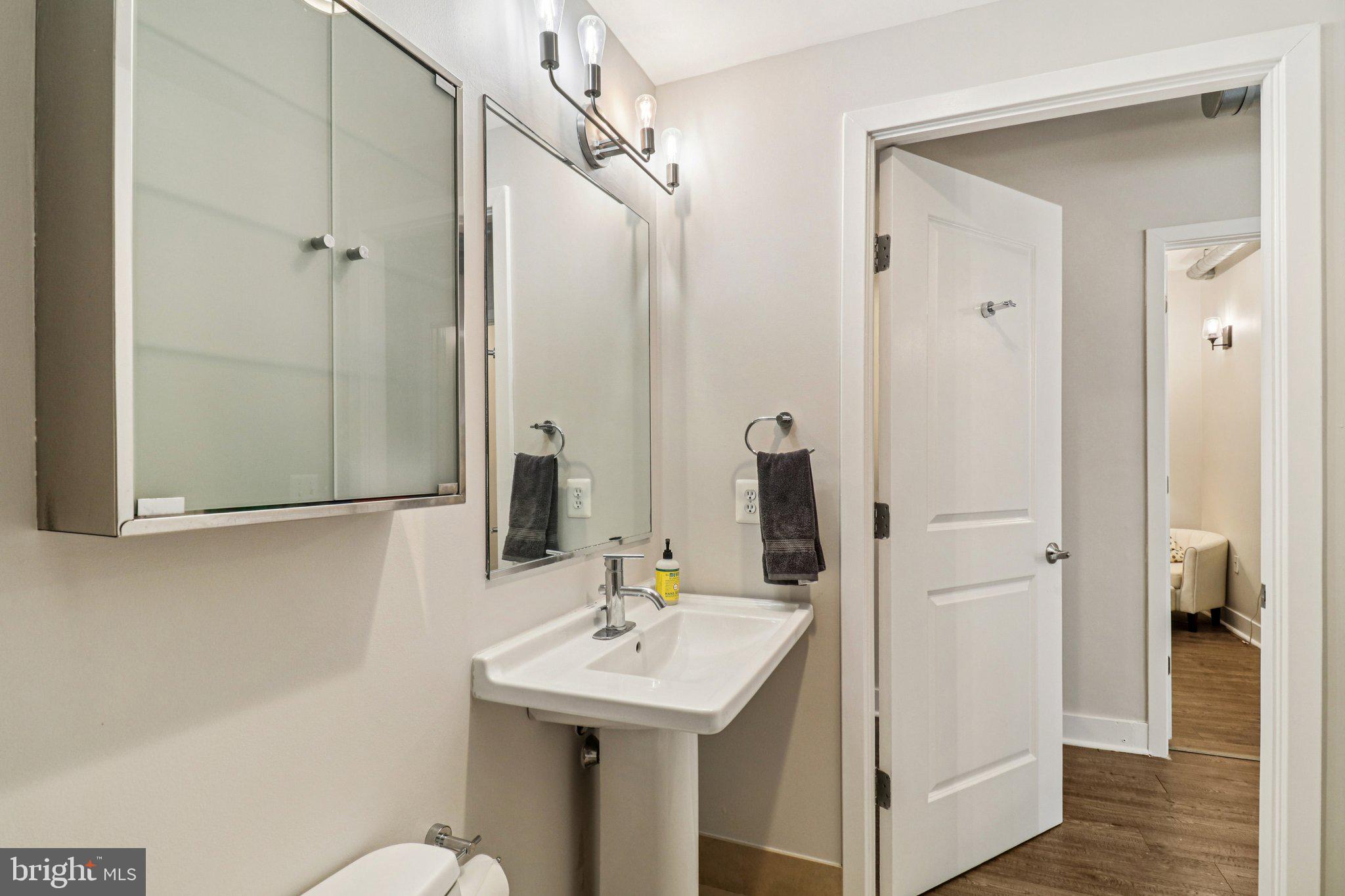 2125 14th Street Northwest, Unit 322 Washington, DC 20009 - Photo 23 of 37 a bathroom with a sink a toilet and shower