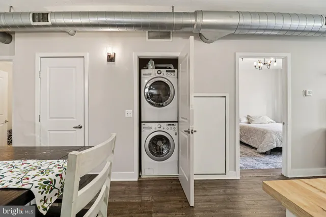 a view of a bedroom with washer and dryer