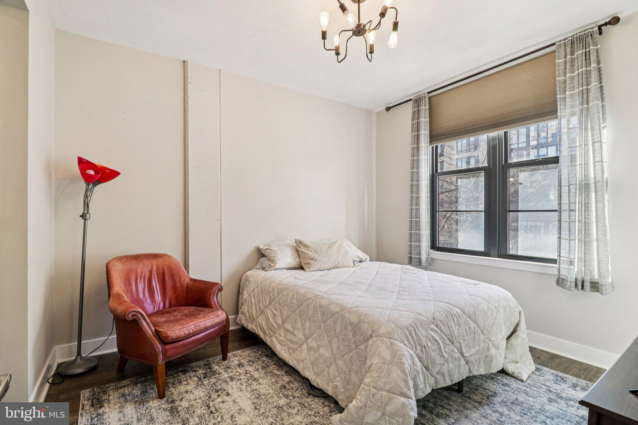 2125 14th Street Northwest, Unit 322 Washington, DC 20009 - Photo 25 of 37 a bedroom with a bed and a chair