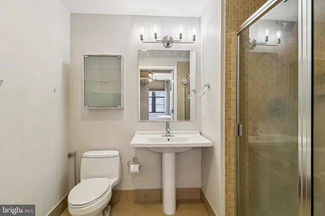 a bathroom with a sink a toilet and mirror
