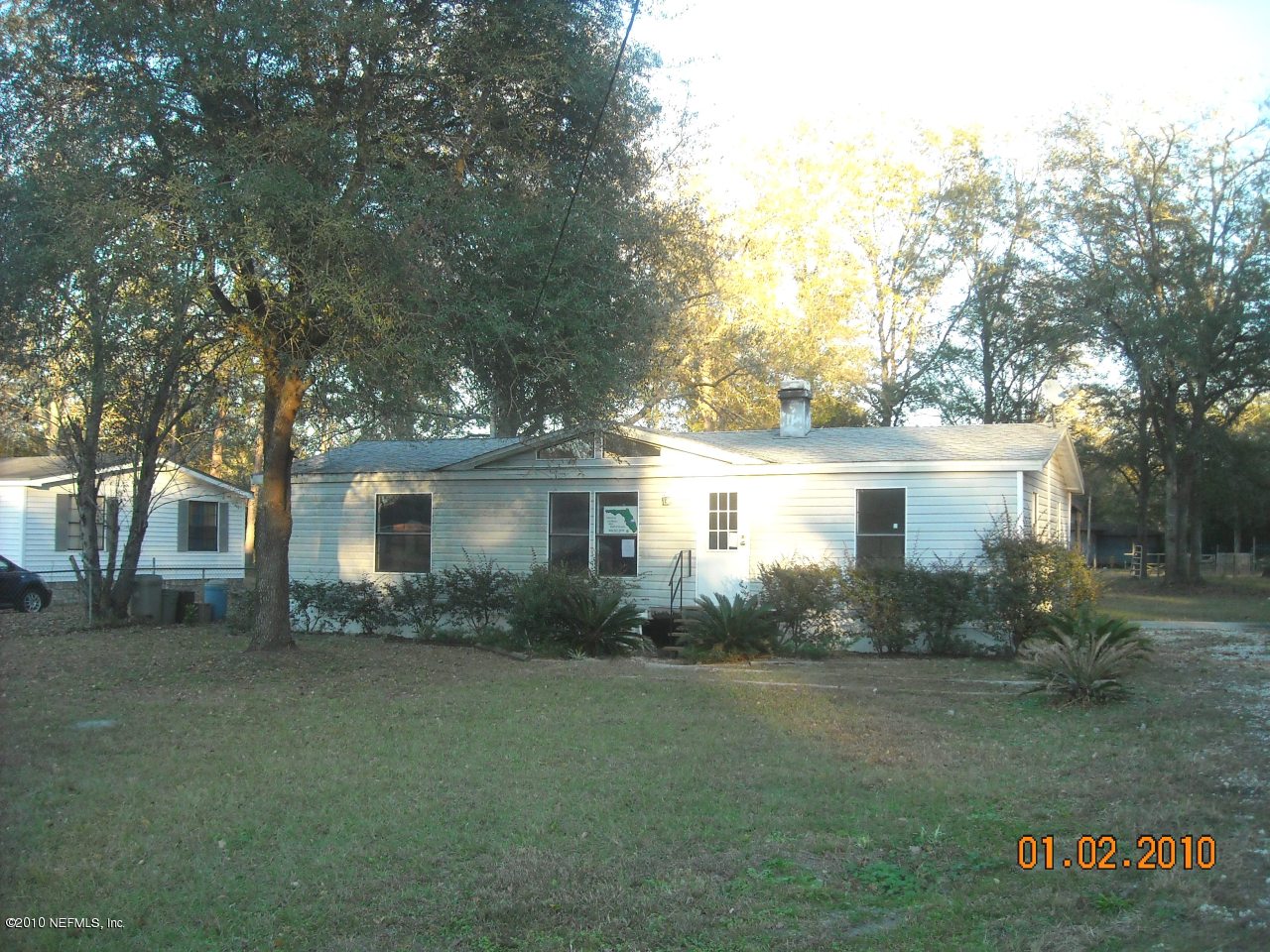 2439 Chuck Road Jacksonville, FL 32221 - Photo 1 of 4 a front view of house with yard and trees around