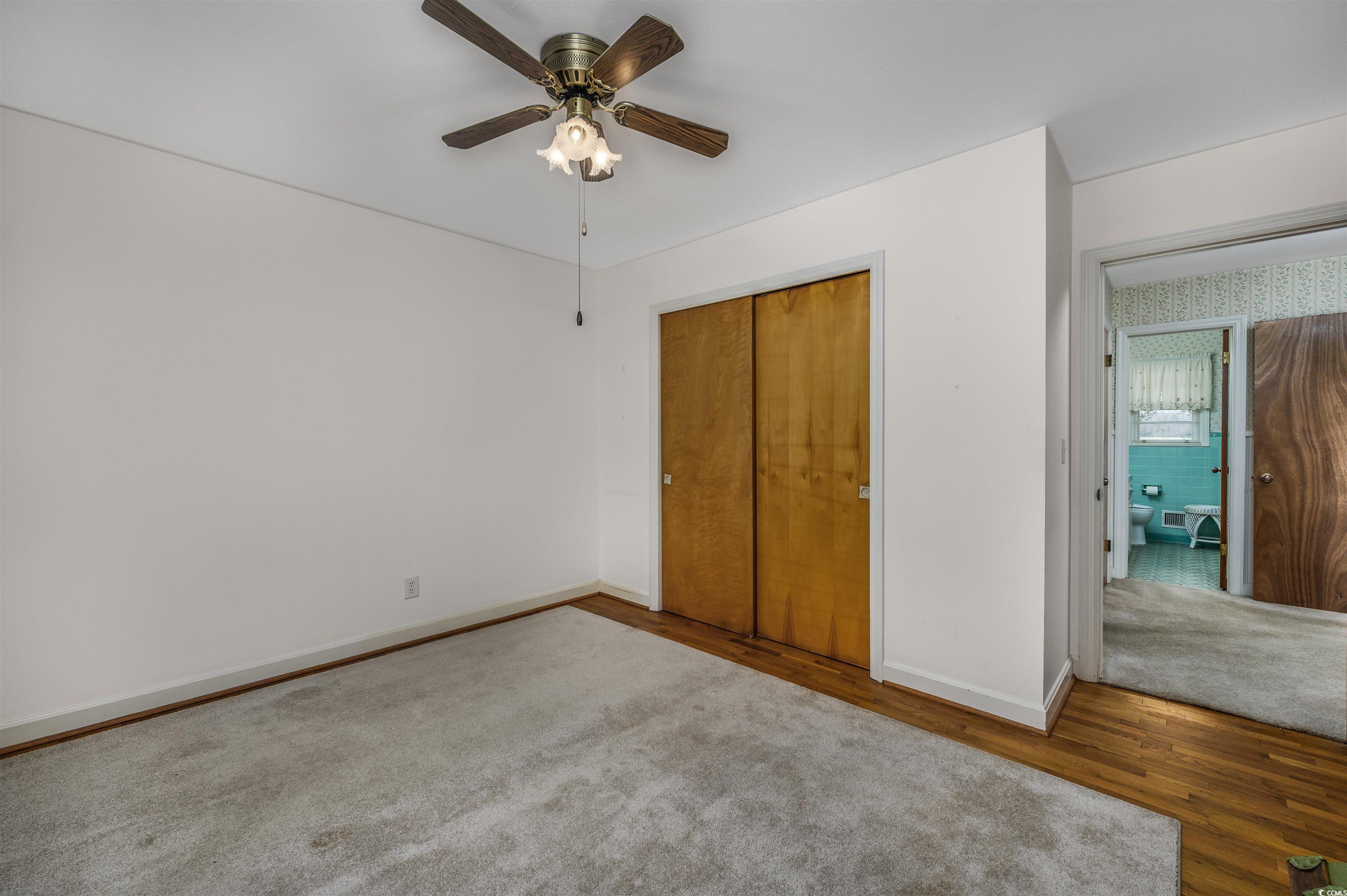 1870 Highway 348 Loris, SC 29569 - Photo 19 of 34 Unfurnished bedroom featuring wood finished floors, a closet, and a ceiling fan