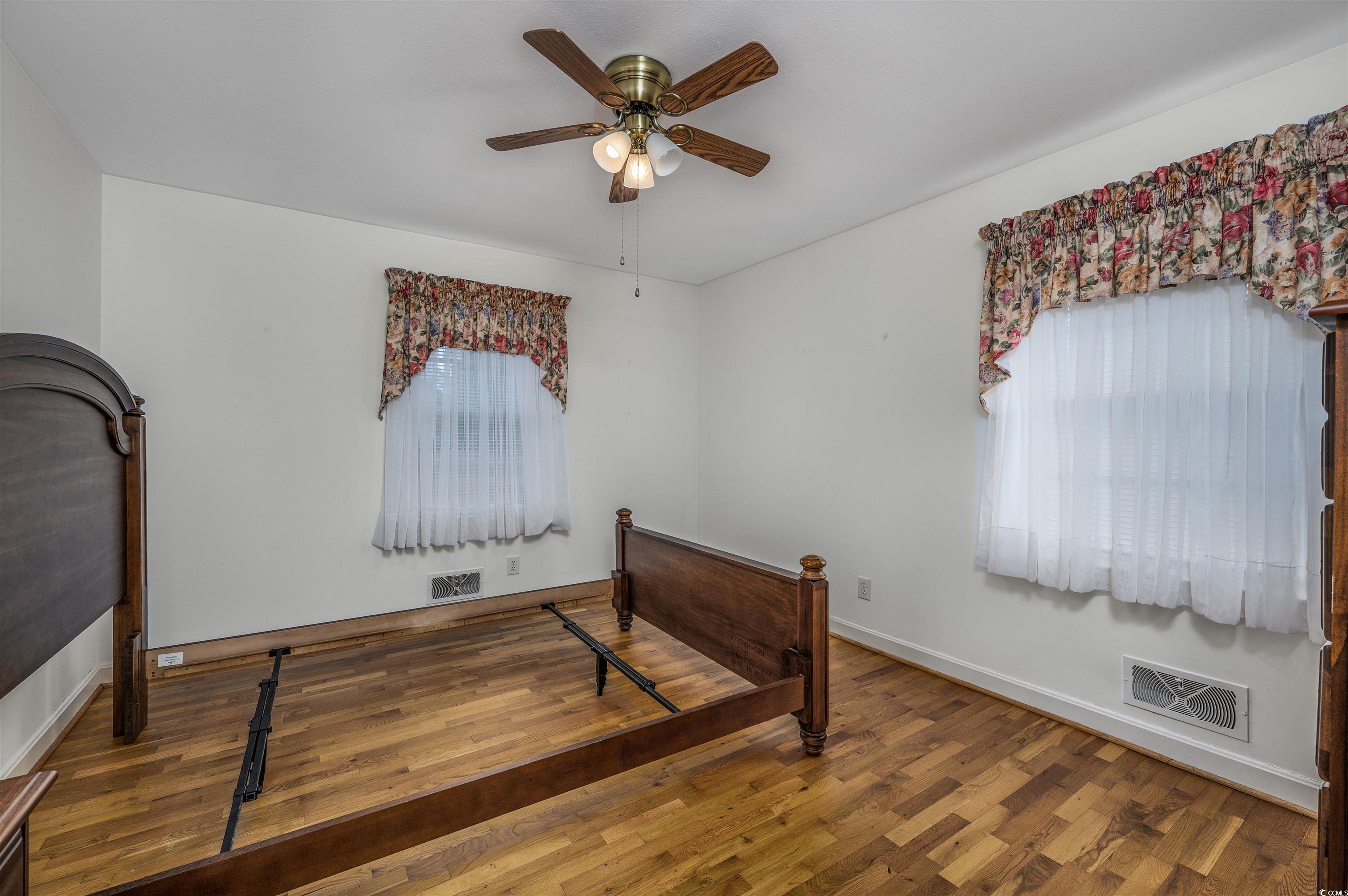 1870 Highway 348 Loris, SC 29569 - Photo 20 of 34 Bedroom with wood-type flooring, a ceiling fan, and multiple windows
