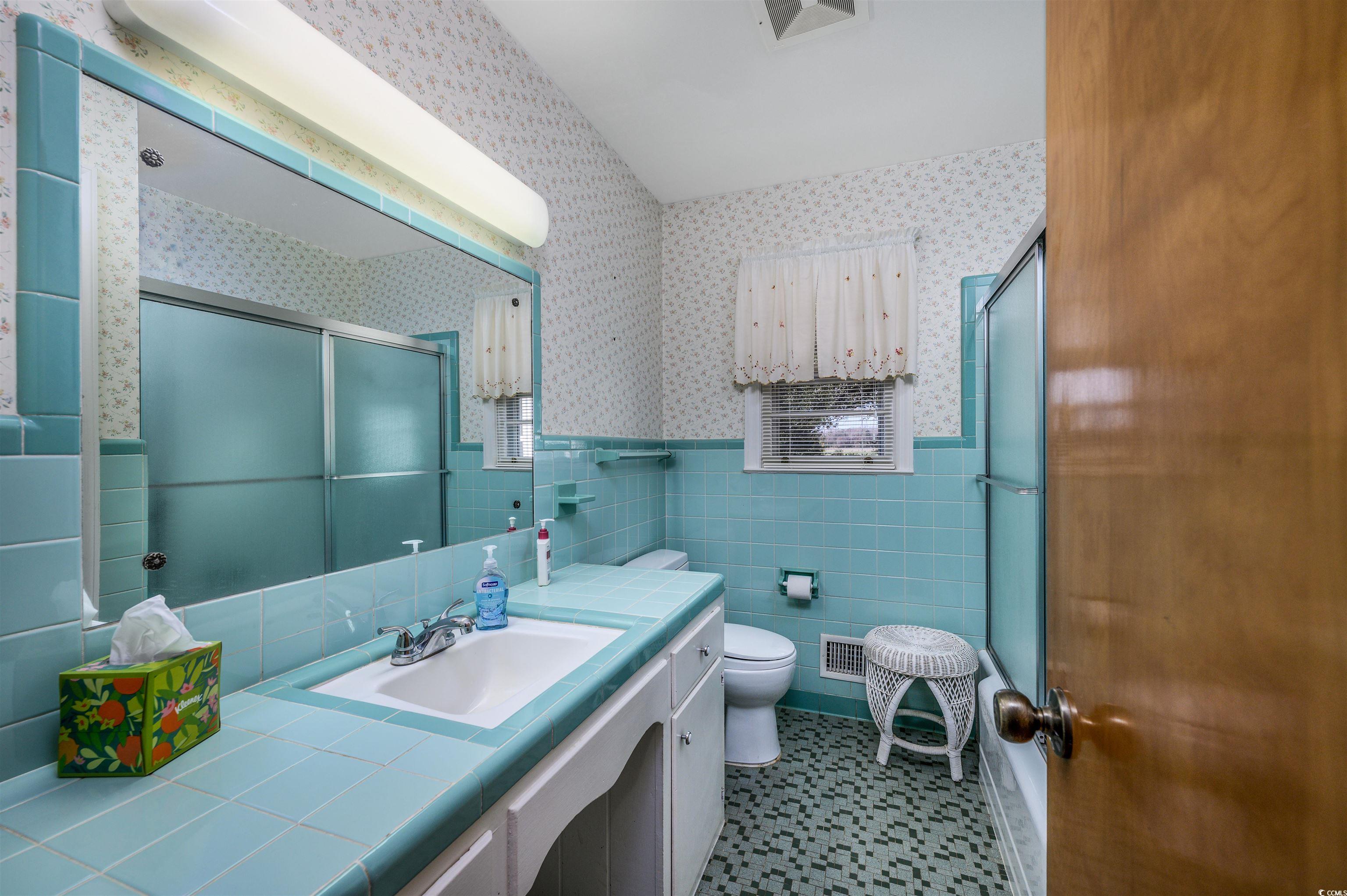 1870 Highway 348 Loris, SC 29569 - Photo 21 of 34 Full bath with wainscoting, a shower stall, tile walls, vanity, and wallpapered walls