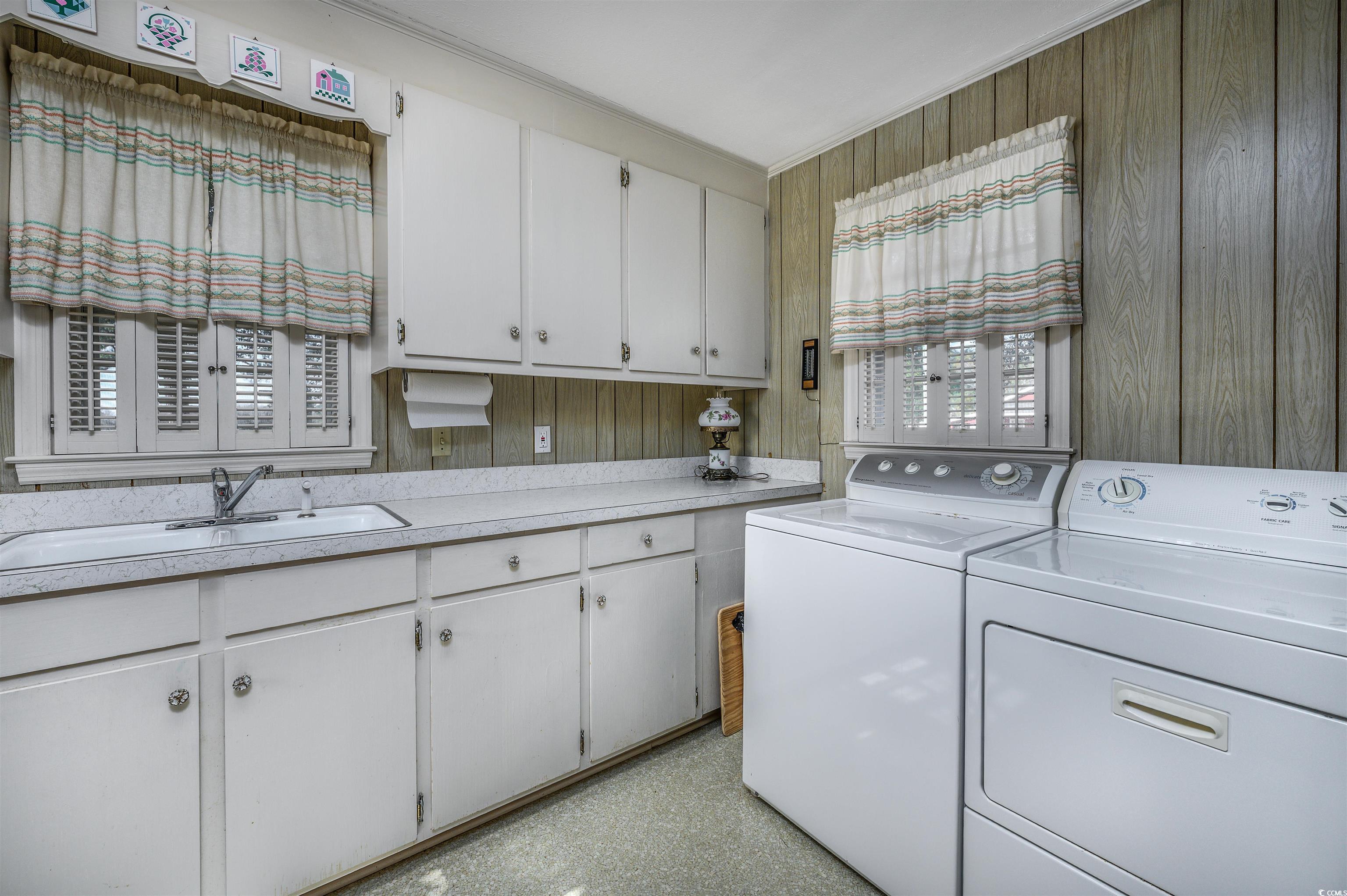 1870 Highway 348 Loris, SC 29569 - Photo 23 of 34 Washroom with wooden walls, washing machine and clothes dryer, and cabinet space