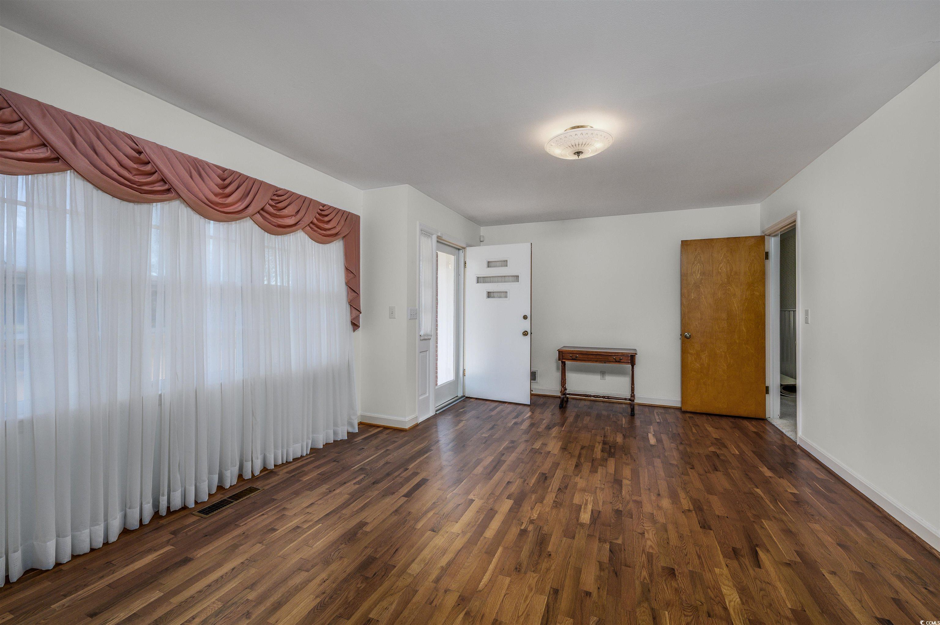 1870 Highway 348 Loris, SC 29569 - Photo 4 of 34 Unfurnished room featuring dark wood-type flooring and baseboards