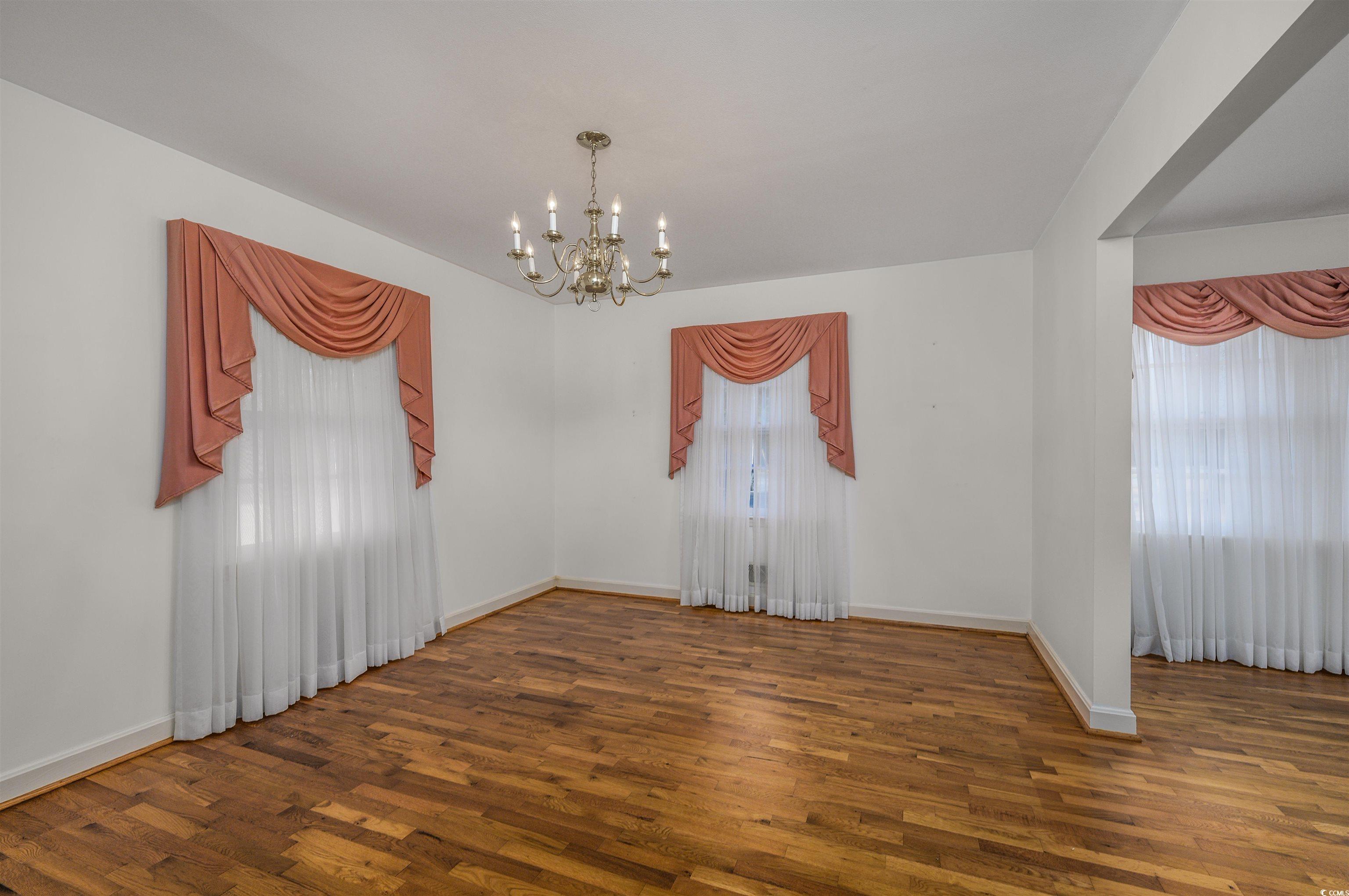 1870 Highway 348 Loris, SC 29569 - Photo 5 of 34 Formal Dining Room featuring wood finished floors and a chandelier