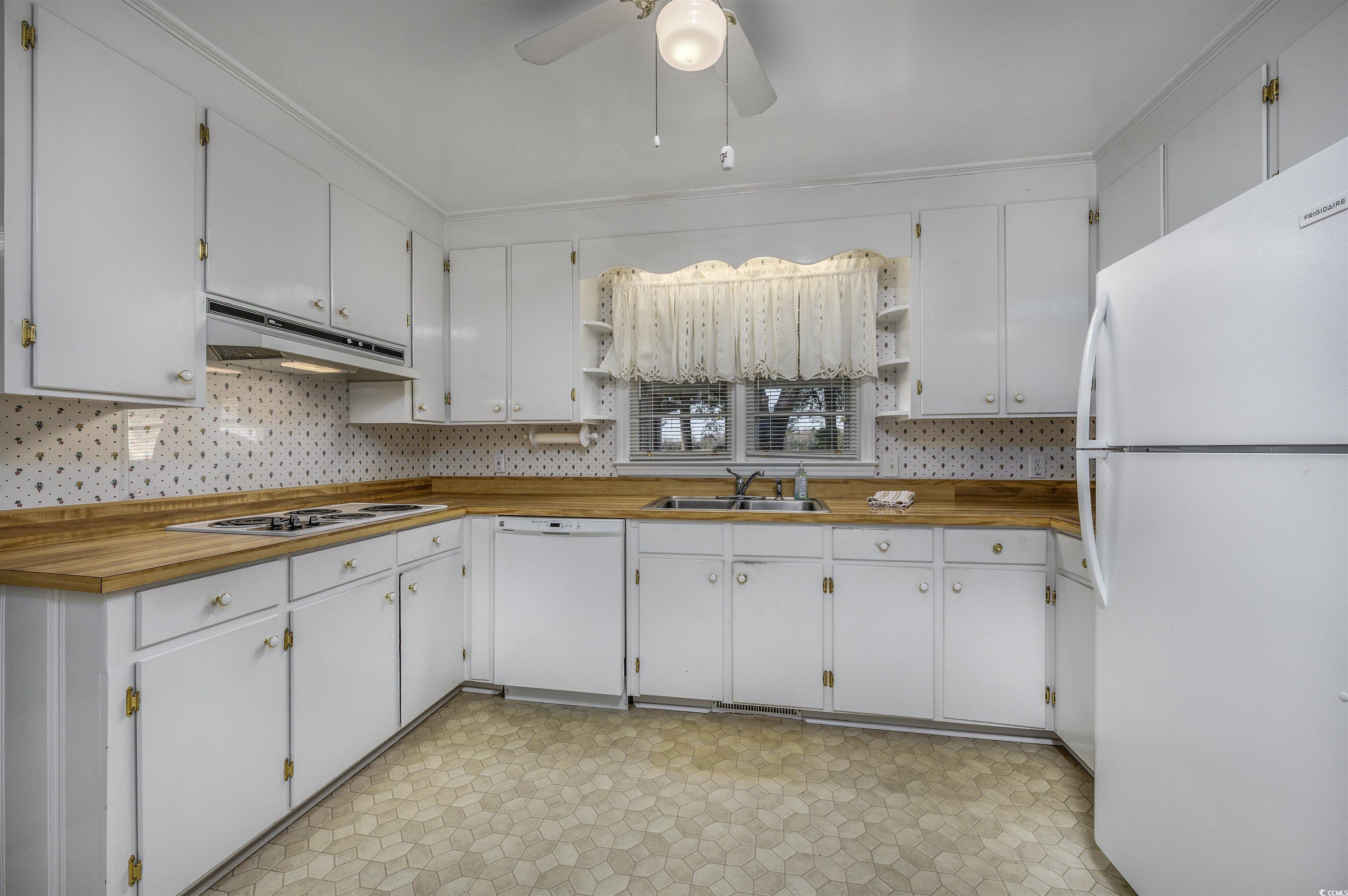 1870 Highway 348 Loris, SC 29569 - Photo 9 of 34 Kitchen featuring light flooring, open shelves, white appliances, wooden counters, and white cabinetry