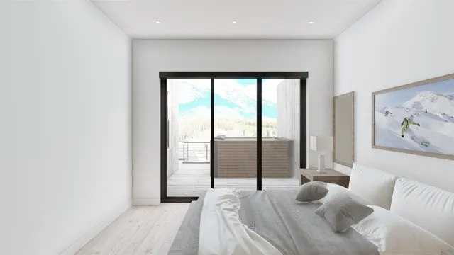 a bedroom with furniture and a large window