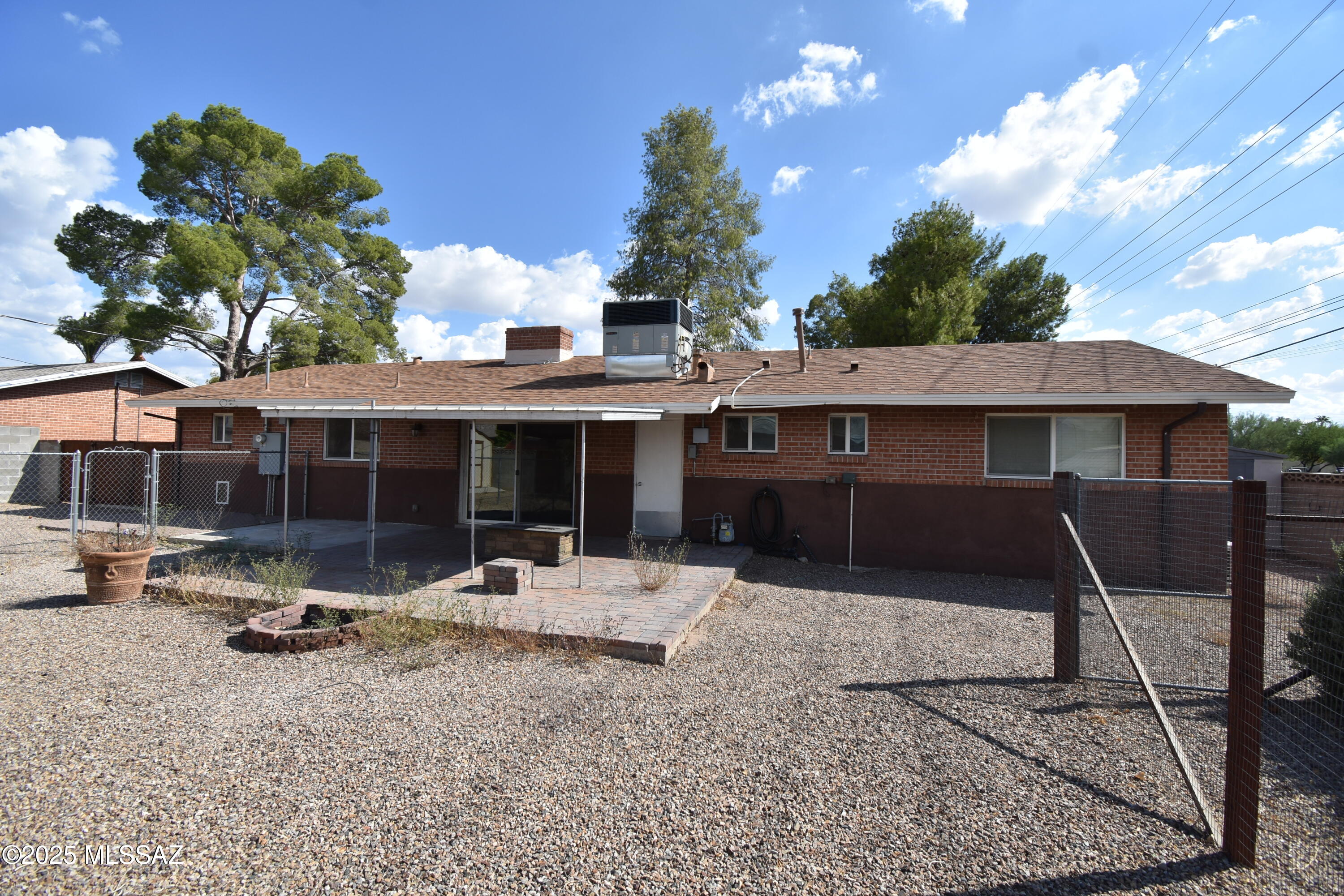 5501 East Spring Street Tucson, AZ 85712 - Photo 3 of 32 a backyard of a house with table and chairs