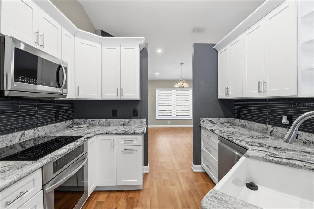20781 Southwest 90th Loop Dunnellon, FL 34431 - Photo 13 of 46 a kitchen with a stove and a microwave
